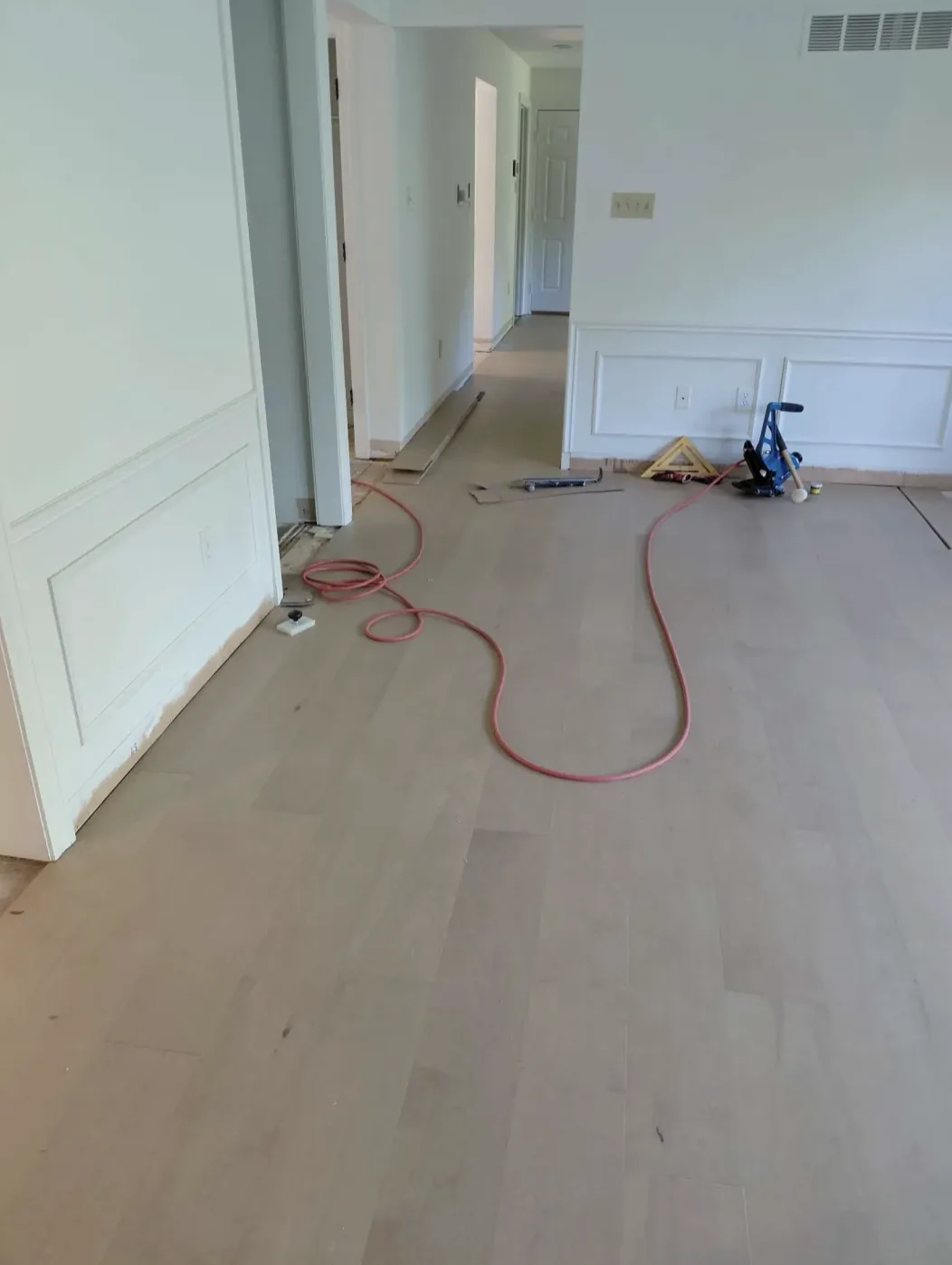 Light wood floor mid-installation in an empty room
