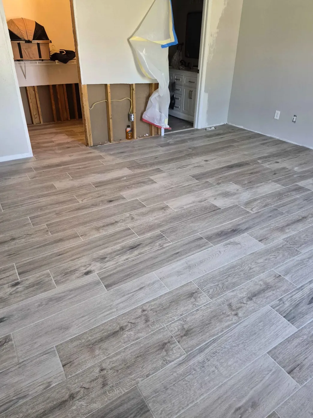 Gray wood-look plank floor installed in a room under renovation